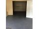 Room with neutral walls and dark flooring leading into another room with block walls, accessible through a white door at 5734 Wellborn Oaks Ct, Lithonia, GA 30058