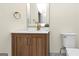 Well-lit bathroom featuring modern fixtures, a wood vanity, and white countertop at 1188 Oakland Sw Ln, Atlanta, GA 30310
