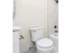 Bright bathroom featuring a toilet, bathtub with shower, and white marble-like tile at 1188 Oakland Sw Ln, Atlanta, GA 30310