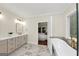 Relaxing bathroom showcases a soaking tub, double vanity with marble countertop, and elegant fixtures near the bedroom at 1188 Oakland Sw Ln, Atlanta, GA 30310