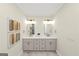 Elegant bathroom features a double vanity with marble countertop and gold fixtures, complemented by decorative mirrors at 1188 Oakland Sw Ln, Atlanta, GA 30310