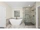 Bright bathroom featuring a soaking tub and glass enclosed shower at 1188 Oakland Sw Ln, Atlanta, GA 30310