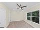 Bedroom with neutral walls, carpet flooring, ceiling fan, and a large window at 1188 Oakland Sw Ln, Atlanta, GA 30310