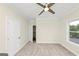 Neutral bedroom featuring plush carpet, a window, and ceiling fan at 1188 Oakland Sw Ln, Atlanta, GA 30310