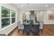 Dining room with glass table, hardwood floors, modern chandelier, and natural light at 1188 Oakland Sw Ln, Atlanta, GA 30310