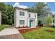 Charming two-story home featuring a modern design with a bright blue front door and fresh landscaping at 1188 Oakland Sw Ln, Atlanta, GA 30310