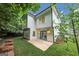 A modern two-story home with white siding, a well-maintained lawn, and access to a backyard patio at 1188 Oakland Sw Ln, Atlanta, GA 30310