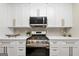 Close-up of a kitchen area featuring stainless steel oven, a modern microwave, and bright white cabinets at 1188 Oakland Sw Ln, Atlanta, GA 30310