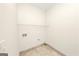 Empty laundry room area with tile floors and hookups for laundry machine at 1188 Oakland Sw Ln, Atlanta, GA 30310
