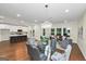 Spacious open-concept living and dining area, featuring hardwood floors and a modern chandelier at 1188 Oakland Sw Ln, Atlanta, GA 30310