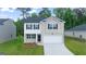 Charming two-story home featuring white brick, black shutters, and a well-manicured lawn at 600 Whitman Ln # 2026, Stockbridge, GA 30281