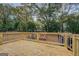 Wooden deck featuring sturdy railings, new lumber, and a private backyard surrounded by mature trees at 5122 Hillcrest Nw Dr, Covington, GA 30014