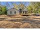 Backyard view of home and deck surrounded by mature trees at 5122 Hillcrest Nw Dr, Covington, GA 30014