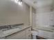 Bathroom featuring granite countertops, tile floors and a tub shower at 5122 Hillcrest Nw Dr, Covington, GA 30014