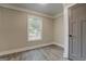 Bedroom featuring modern wood floors, neutral walls, crown molding and a window with natural light at 5122 Hillcrest Nw Dr, Covington, GA 30014