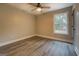 Bedroom with wood-look flooring, ceiling fan, and a window at 5122 Hillcrest Nw Dr, Covington, GA 30014