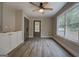 Bright dining room featuring a ceiling fan, luxury vinyl flooring, and freshly painted gray trim at 5122 Hillcrest Nw Dr, Covington, GA 30014