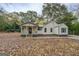 Quaint one-story home featuring a welcoming covered porch and charming curb appeal at 5122 Hillcrest Nw Dr, Covington, GA 30014