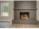 Classic brick fireplace with hearth and mantel, complemented by a large window at 5122 Hillcrest Nw Dr, Covington, GA 30014