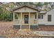 Inviting covered porch with wooden railings and steps, perfect for relaxing at 5122 Hillcrest Nw Dr, Covington, GA 30014