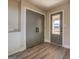 Hallway featuring a large pantry, luxury vinyl flooring, and freshly painted gray trim at 5122 Hillcrest Nw Dr, Covington, GA 30014