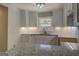 Bright kitchen features white cabinets, granite countertops, and modern lighting at 5122 Hillcrest Nw Dr, Covington, GA 30014