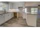Bright kitchen with white cabinets, granite countertops, and modern flooring at 5122 Hillcrest Nw Dr, Covington, GA 30014