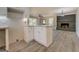 Open concept living area with white kitchen island and brick fireplace at 5122 Hillcrest Nw Dr, Covington, GA 30014
