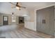 Spacious living room showcasing modern floors, storage cabinet, a brick fireplace, and a neutral color palette at 5122 Hillcrest Nw Dr, Covington, GA 30014
