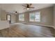 Bright living room featuring modern wood floors, neutral walls, a front door and windows with natural light at 5122 Hillcrest Nw Dr, Covington, GA 30014