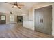 Open-concept living area with kitchen island, fireplace, and modern gray doors at 5122 Hillcrest Nw Dr, Covington, GA 30014