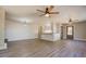 Open-concept living room with kitchen, wood-look floors, and ceiling fans at 5122 Hillcrest Nw Dr, Covington, GA 30014