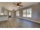 Spacious living area with hardwood floors, multiple windows, and a ceiling fan at 5122 Hillcrest Nw Dr, Covington, GA 30014