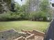 Large, green backyard featuring a stepped garden and a natural wood fence at 362 Mayfield Cir, Alpharetta, GA 30009