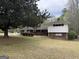 Charming brick home with manicured landscaping and a cozy outdoor seating area at 362 Mayfield Cir, Alpharetta, GA 30009