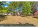 Large, private backyard featuring mature trees and ample green space at 6566 Chestnut Oaks Rdg, Lithonia, GA 30038