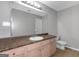 Neutral bathroom features an extended vanity and tile flooring at 6566 Chestnut Oaks Rdg, Lithonia, GA 30038