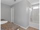 Bright bathroom featuring a shower-tub combo, tiled floors, and white trim at 6566 Chestnut Oaks Rdg, Lithonia, GA 30038