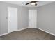 Bedroom featuring neutral carpeting and walls and two white paneled doors at 6566 Chestnut Oaks Rdg, Lithonia, GA 30038