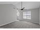Spacious primary bedroom features neutral paint, new carpeting and modern ceiling fan at 6566 Chestnut Oaks Rdg, Lithonia, GA 30038