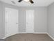 Bedroom featuring carpet flooring, neutral colored walls, and two white paneled doors at 6566 Chestnut Oaks Rdg, Lithonia, GA 30038