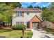 Two-story home with a charming brick facade and well-maintained lawn, creating a welcoming curb appeal at 6566 Chestnut Oaks Rdg, Lithonia, GA 30038