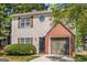 Two-story home with a charming brick facade, complemented by lush trees and a well-maintained lawn at 6566 Chestnut Oaks Rdg, Lithonia, GA 30038