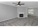 Neutral living room features plush carpet, fireplace, and natural light creating an inviting and comfortable space at 6566 Chestnut Oaks Rdg, Lithonia, GA 30038