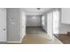 The home features a spacious living room area with neutral colored walls and carpet at 6566 Chestnut Oaks Rdg, Lithonia, GA 30038