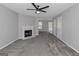 Spacious living room features a cozy fireplace, plush carpet, and ample natural light, creating a comfortable atmosphere at 6566 Chestnut Oaks Rdg, Lithonia, GA 30038