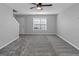 Bright living room with a ceiling fan, plush carpet, and neutral paint creates an inviting and comfortable space at 6566 Chestnut Oaks Rdg, Lithonia, GA 30038