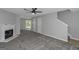 Neutral living room features plush carpet, and access to the backyard and stairs creating an inviting space at 6566 Chestnut Oaks Rdg, Lithonia, GA 30038