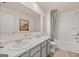 Well-lit bathroom featuring a double sink vanity and a bathtub-shower combination with stylish curtain at 596 Whitman Lane # 2025, Stockbridge, GA 30281