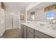 Bathroom featuring a double sink vanity, large mirror, patterned window treatments and glass shower doors at 596 Whitman Lane # 2025, Stockbridge, GA 30281